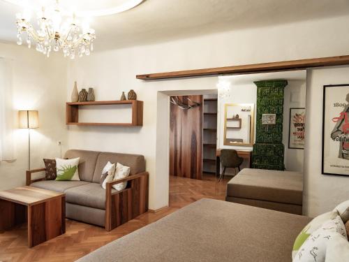 a living room with a couch and a table at Romantik Hotel Jagdhof in Caldaro