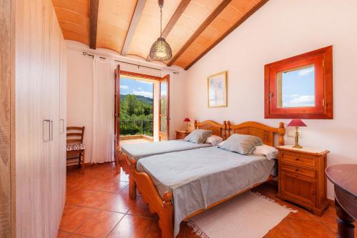 a bedroom with two beds and a window at Es Turó de Son Mel in Petra