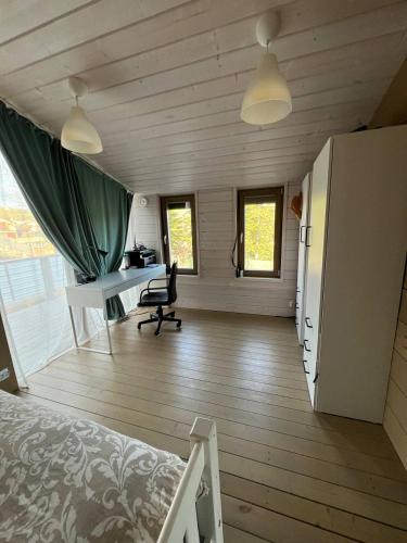 a bedroom with a bed and a desk in a room at La Dacha Montanya in Seva