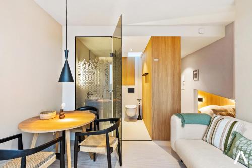 a living room with a table and a couch at Modern and Cozy Studio Retreat near the City in Luxembourg