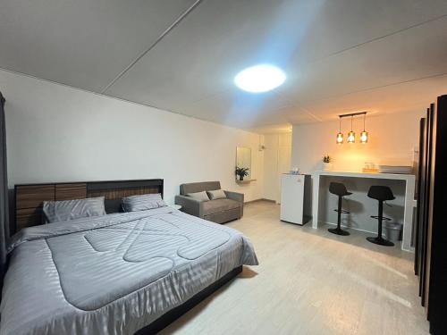 a bedroom with a large bed and a desk at T12 Popular Condo By hunnity 2 in Ban Bang Phang
