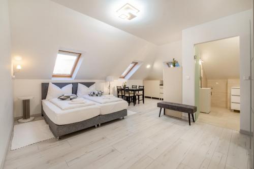 a bedroom with a bed and a dining room at JIN JANG Apartman Veszprém in Veszprém