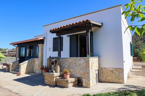 a white house with a stone wall at Villa Scaiano by Salento Prime in Salve