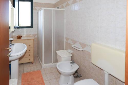 a bathroom with a toilet and a sink and a shower at Villa Scaiano by Salento Prime in Salve
