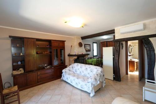 a bedroom with a bed and a kitchen with a refrigerator at Villa Scaiano by Salento Prime in Salve