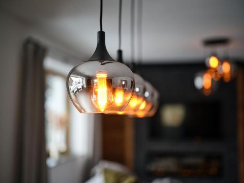 a glass light bulb hanging from a ceiling at Lodge am Wetterstein in Ehrwald