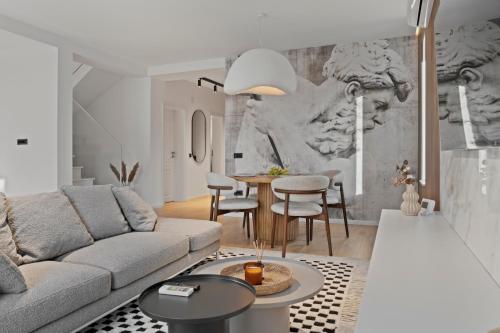 a living room with a couch and a table at VILLA THERME - Luxurious Villa near Therme SPA & Airport in Corbeanca