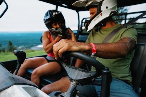 a man and a woman wearing helmets on a bike at Camelback Resort in Tannersville