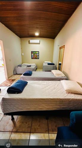 a room with three beds in a room at Residencial Celedone in Boa Vista