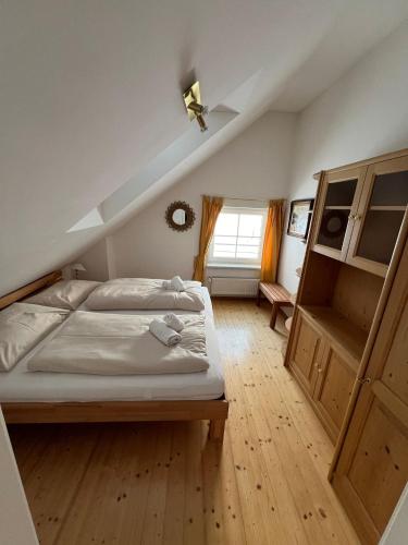 a bedroom with a large bed and a window at Fewo-Obertauern Maisonette in Obertauern