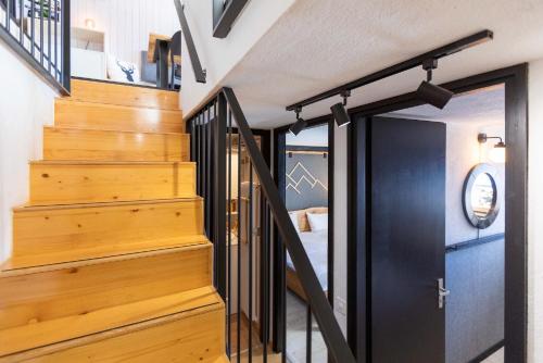a staircase in a house with wooden floors at Hunter Lodge by Gryon Confort in Gryon