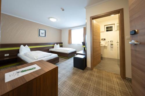 Postel nebo postele na pokoji v ubytování Primus Hotel & Apartments