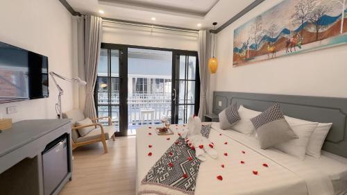 a bedroom with a bed with red hearts on it at LuangPrabang Orient Boutique Hotel in Luang Prabang
