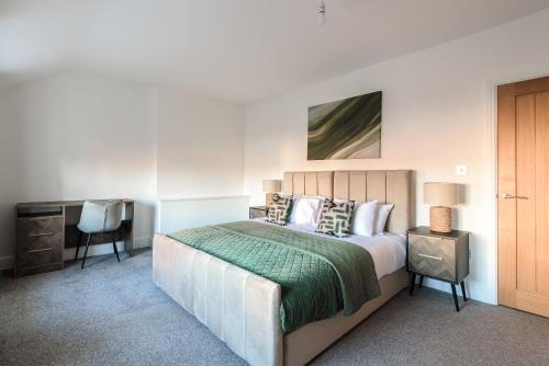 a bedroom with a bed with a desk and a chair at The Old Embassy by Guestz in Hull