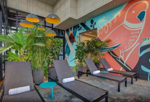 a group of chairs and plants in a lobby at Radisson Blu São Paulo in Sao Paulo