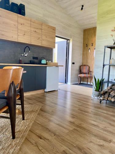 a kitchen with wooden floors and a table in a room at Sauna for celebration and leisure in Grygaytse