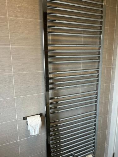 a bathroom with a shower with a roll of toilet paper at Wonderful two bedroom house in Bicester in Chesterton