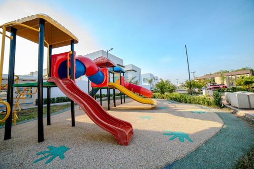 a playground with a slide in a park at Espectacular Casa de Ensueño "Jacuzzi Privado" en Ricaurte - Peñalisa in Ricaurte