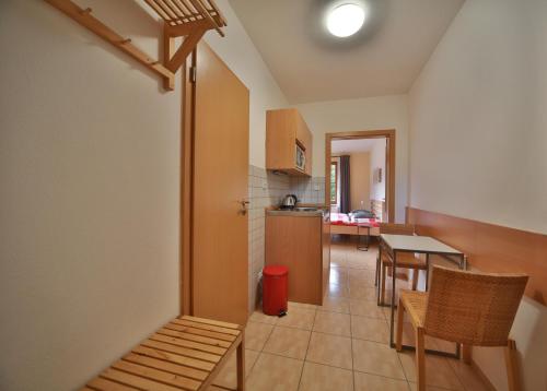 a kitchen and dining room with a table and chairs at Apartmány U šneka in Železná Ruda