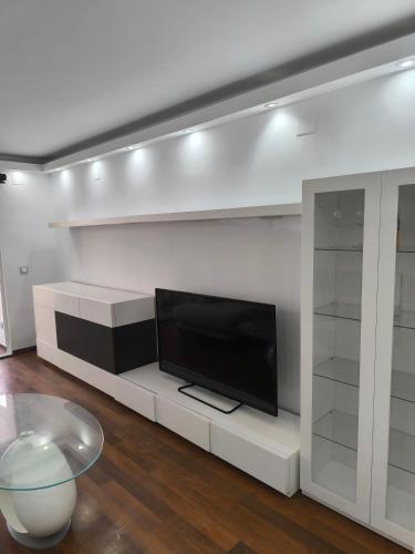 a living room with a tv on a white wall at vero in El Campello