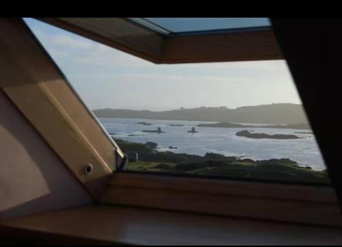 a view of the ocean from a window on an airplane at The Roundhouse in Lettermullan
