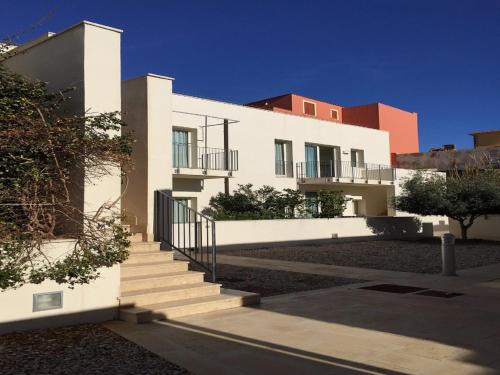 a white building with stairs in front of it at Cala Palme Lampedusa in Lampedusa