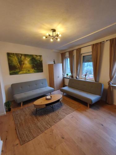 a living room with two couches and a coffee table at FlexHome Stilvolle Ferienwohnung in Lippstadt