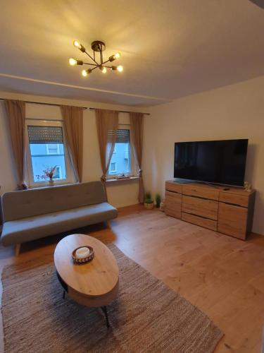 a living room with a couch and a flat screen tv at FlexHome Stilvolle Ferienwohnung in Lippstadt