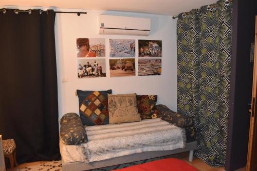 a room with a couch and pictures on the wall at La Conté in La Coste