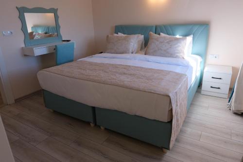 a bedroom with a large bed with a mirror on the wall at Şahin Tepesi Suite Otel in Trabzon