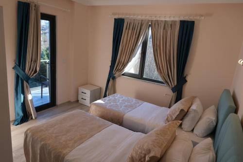a bedroom with two beds and a window at Şahin Tepesi Suite Otel in Trabzon