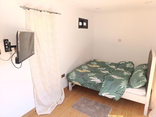 a bedroom with a bed and a shower curtain at Cozi Gardens Syokimau-Katani road 30min to SGR NBO Expressway & JKIA in Syokimau