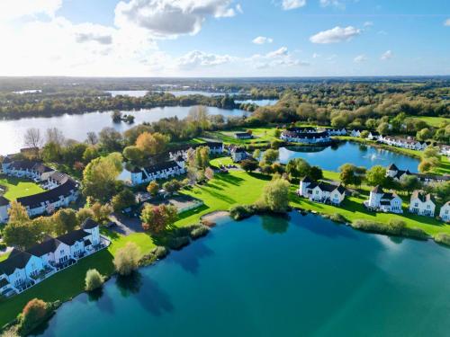 an aerial view of a home on the water at Nyhavn Lakeside Cottage in Cirencester