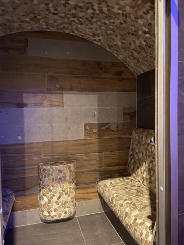 a living room with a couch and a chair at Apartmán 405 Hotel OVRUČ in Štrbské Pleso
