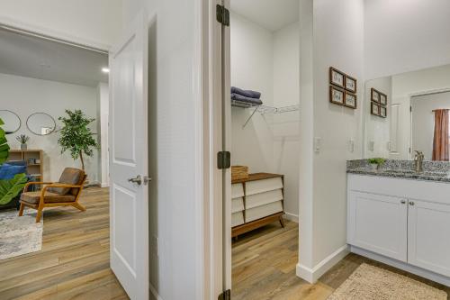 a kitchen with white cabinets and a table at Walkable Downtown LaBelle Apt with Private Balcony! in La Belle