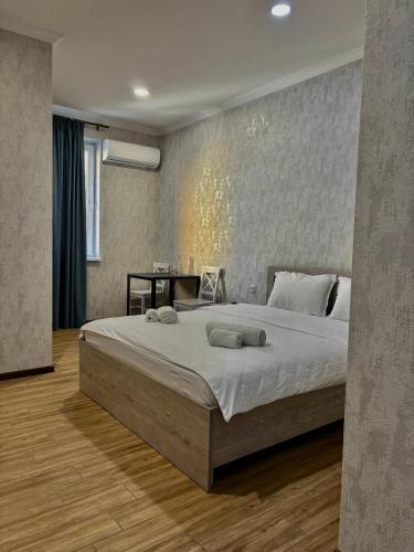 a bedroom with a large bed in a room at Solo Palace in Rustavi