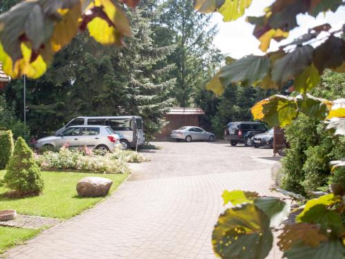 a driveway with cars parked in a parking lot at Hotel & Restaurant Waldschlösschen in Kyritz
