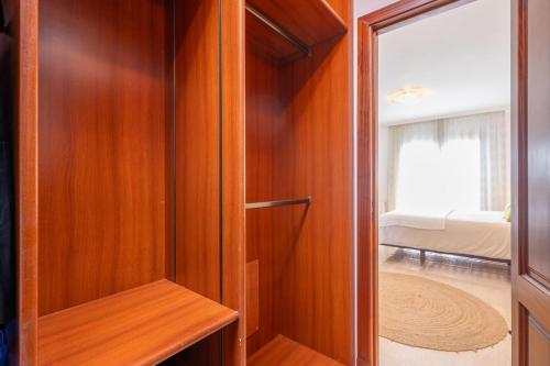 a wooden closet with a door to a bedroom at Can Albons in Portocolom