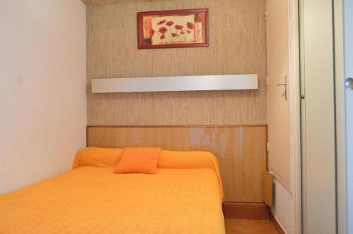 une chambre avec un lit avec une couverture orange dans l'établissement Appartement 2 pièces CAP D'AGDE CT420-121, au Cap d'Agde