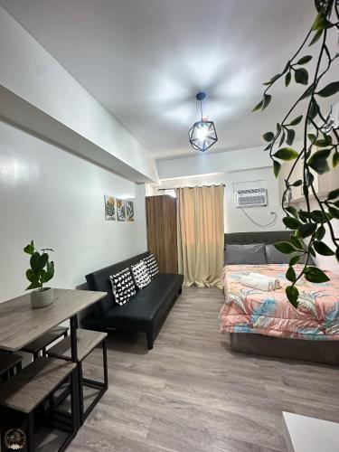 a living room with a couch and a table at Cozy Home in Cebu City