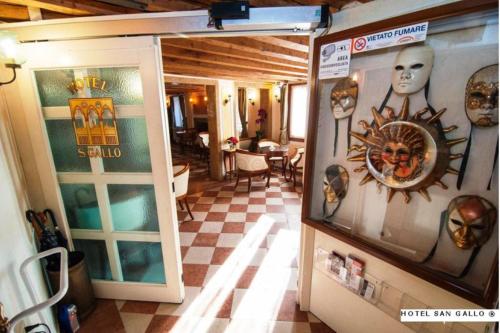 a room with masks on the walls of a restaurant at H O T E L S A N G A L L O l in Venice