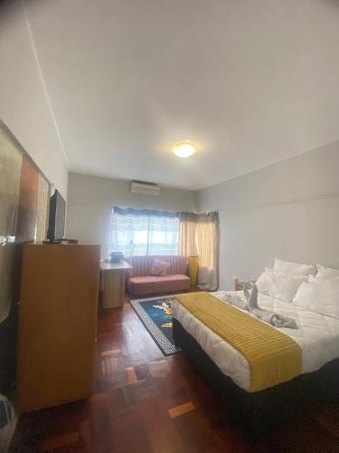 a bedroom with a bed and a living room at Wonderful Guest house in Durban