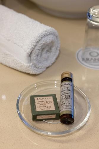 a bottle of medicine on a plate next to a towel at Aranwa Paracas Resort & Spa in Paracas