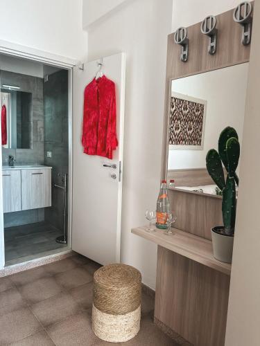 a bathroom with a red shirt hanging on the door at Hotel Maremola in Pietra Ligure