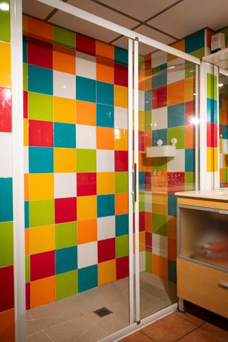 a colorful wall in a kitchen with a glass door at Casa Baja in Valderrobres