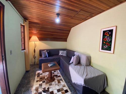 a living room with a couch and a table at Pousada Sotaque Mineiro in Cunha