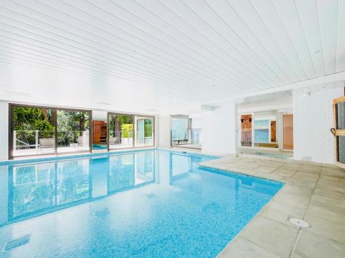 une piscine intérieure d'eau bleue dans un bâtiment dans l'établissement Le Lys - Terrasse Cannes, à Cannes