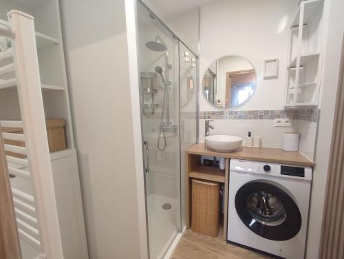 La salle de bains est pourvue d'un lave-linge et d'un miroir. dans l'établissement T2 Le Bohème - climatisé, à Gréoux-les-Bains