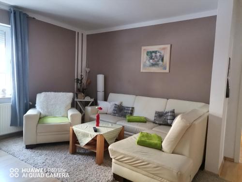 a living room with a couch and two chairs at Ferienwohnung - am- Goethewanderweg in Stützerbach