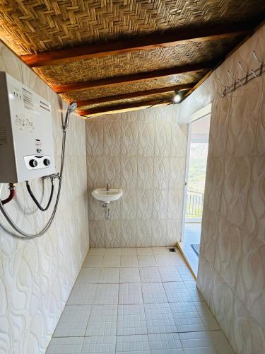 a bathroom with a shower and a sink at Pinggan Campside Glamping in Baturaja